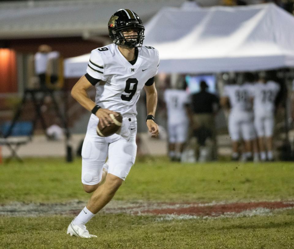 Milton quarterback Emory Williams (No. 9) looks for an open receiver as he runs out of the pocket during Friday night's game against the Raiders.