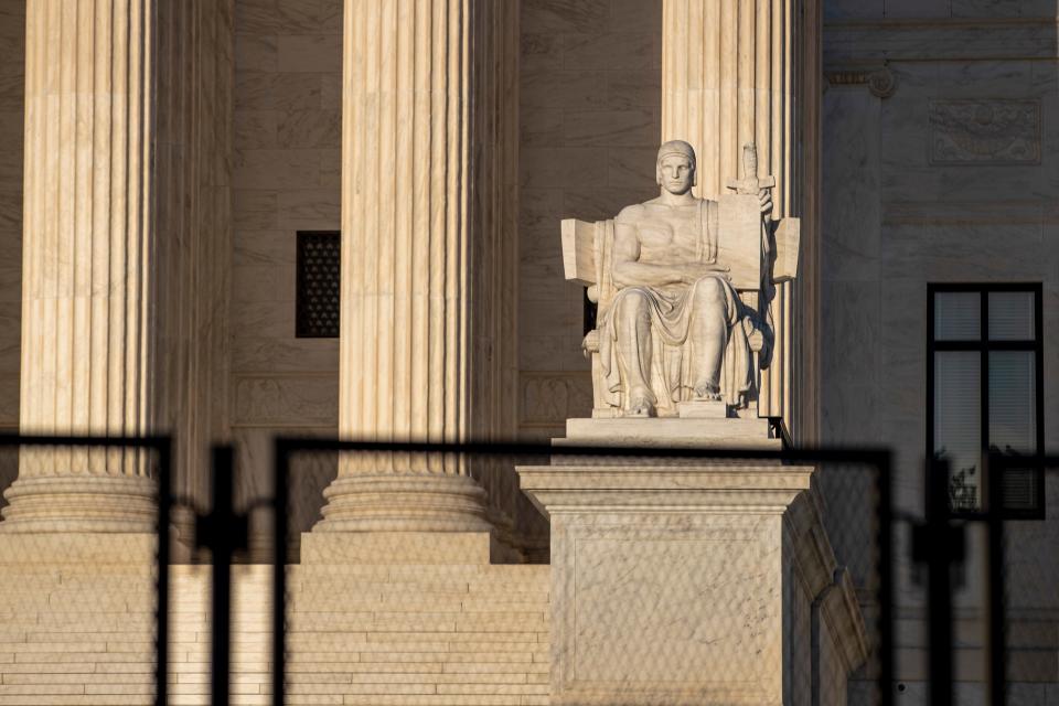 A fence seals off the Supreme Court building as anti-abortion and abortion-rights demonstrators protest on May 10, 2022.