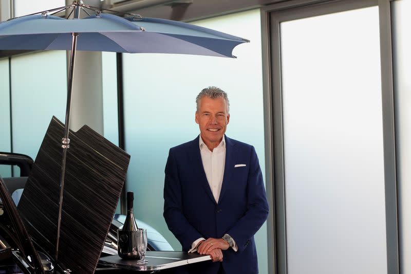 Torsten Muller-Otvos, CEO of Rolls-Royce, poses at a hand made car described as 'the most refined picnic facility on earth', at the company's factory in Goodwood