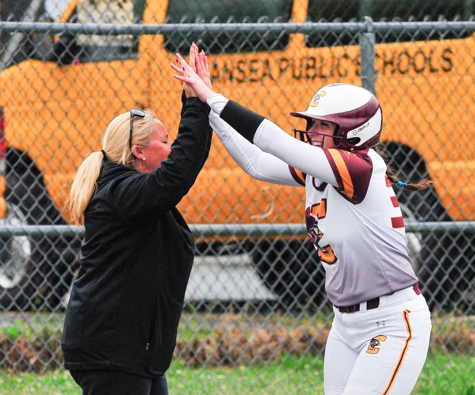 Case’s head coach Shannon Silva congratulates Brooke Perron after hitting her first of two home runs during Thursday’s game against New Bedford.
