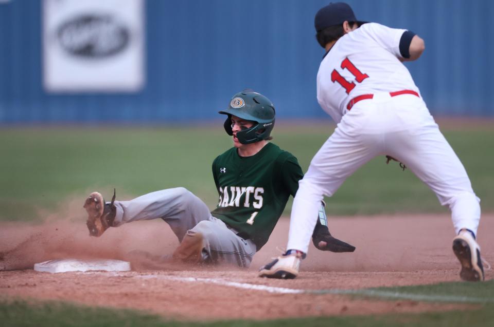 Briarcrest's Joshua Brown slides safely into third base past at St. Benedict at Auburndale's Seamas Carrasco on Monday, April 4, 2022. 