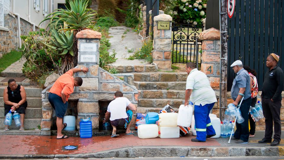 People collect drinking water from in Cape Town on January 19, 2018, during a water crisis which saw the city nearly run dry.  - Rodger Bosch/AFP/Getty Images