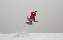 In this Friday, Jan. 24, 2020 photo, Mohammad Farzad, 20, a member of the Afghanistan Snowboarding Federation practices on the hillside known as Kohe Koregh, on the outskirts of Kabul, Afghanistan. While Afghanistan’s capital may seem an unlikely destination for snowboarders, a group of young Afghans is looking to put the city on the winter sports map and change perceptions about their war-weary nation. (AP Photo/Rahmat Gul)