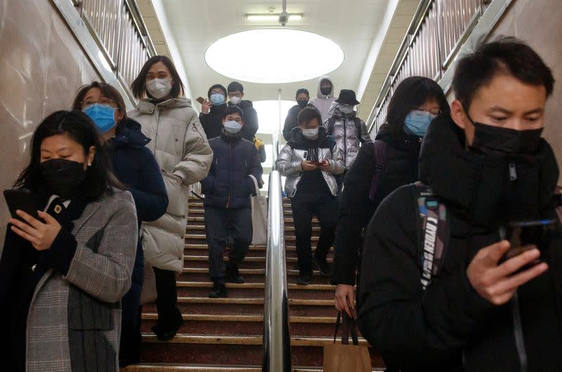 People wear face masks as they change subway lines in Beijing as the country is hit by an outbreak of the novel coronavirus