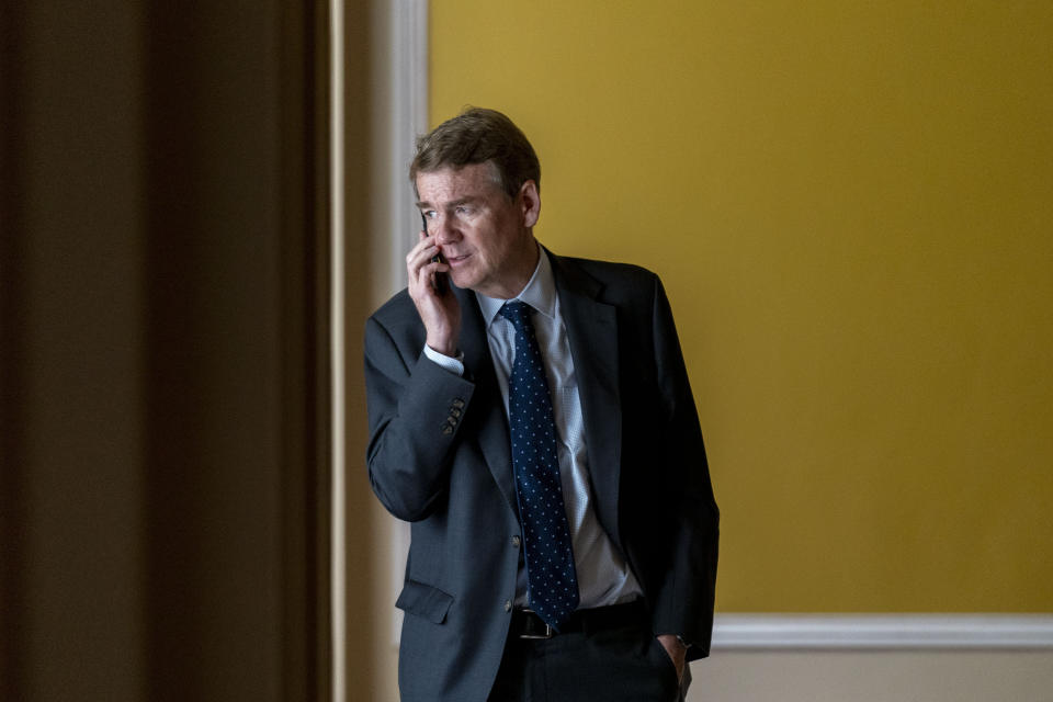 FILE - Sen. Michael Bennet, D-Colo., speaks on a cellphone in a hallway as the House approved a 45-day funding bill to keep federal agencies open, Saturday, Sept. 30, 2023, in Washington. As the Senate wrapped up its work for the year, Bennet took to the floor of the nearly empty chamber and made a late-night plea for Congress to redouble support for Ukraine: “Understand the stakes at this moment." (AP Photo/Andrew Harnik, File)