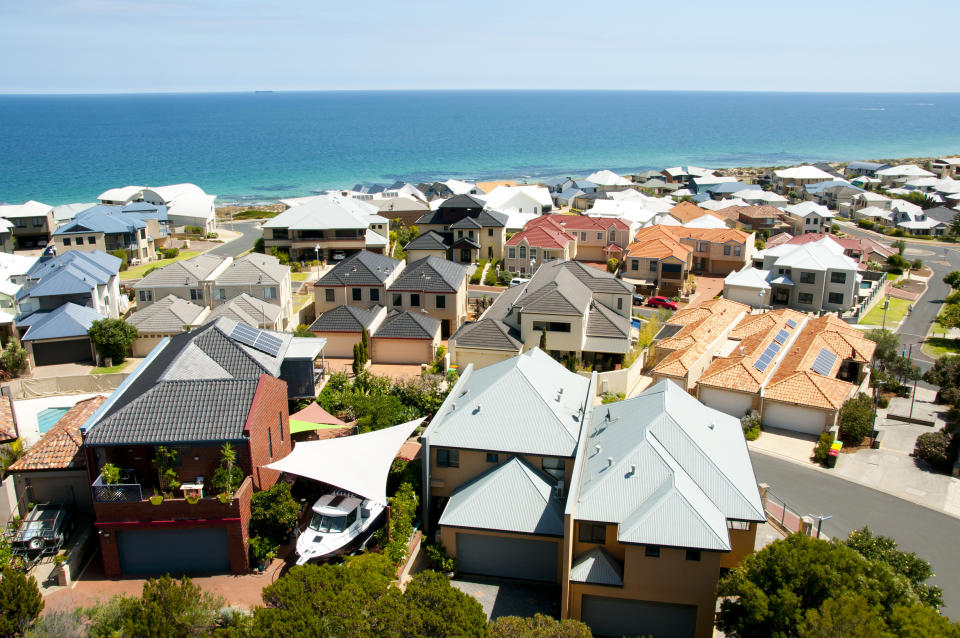 Elevated view of houses overlooking the ocean as interest rates rise.