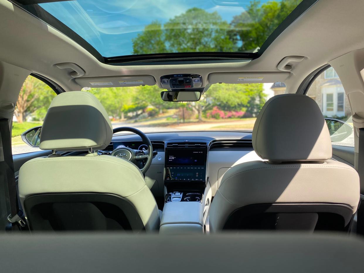 The cabin of a 2024 Hyundai Tucson Hybrid Limited is equipped with a panoramic sunroof.