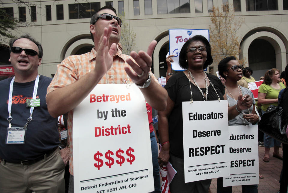 Detroit public school teachers Mark Moran (2nd L) and Debora Jones join other teachers and union members in a rally to demand fair contract negotiations during the American Federation of Teachers (AFT) convention in Detroit, Michigan, July 26, 2012. In the maelstrom of criticism surrounding America's unionized public teachers, Randi Weingarten, the woman running the second-largest educator union says time has come to collaborate on public school reform rather than resist. Photo taken July 26, 2012. REUTERS/Rebecca Cook  (UNITED STATES - Tags: BUSINESS EMPLOYMENT CIVIL UNREST EDUCATION)