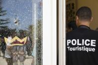 A member of the Tunisian security forces stands guard near a bullet hole on a window at the Riu Imperial Marhaba Hotel in Port el Kantaoui on June 29, 2015