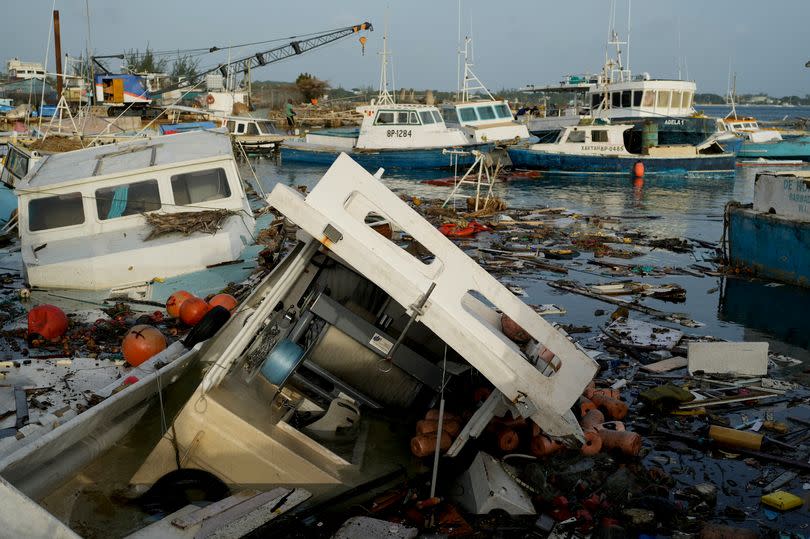 Fishing boats damaged by Hurricane Beryl wade in the water at the Bridgetown Fisheries, Barbados