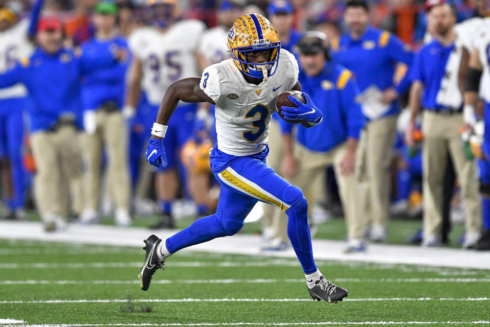 Pittsburgh wide receiver Jordan Addison runs with the ball during the second half of an NCAA college football game against Syracuse in Syracuse, N.Y., Saturday, Nov. 27, 2021. (AP Photo/Adrian Kraus)