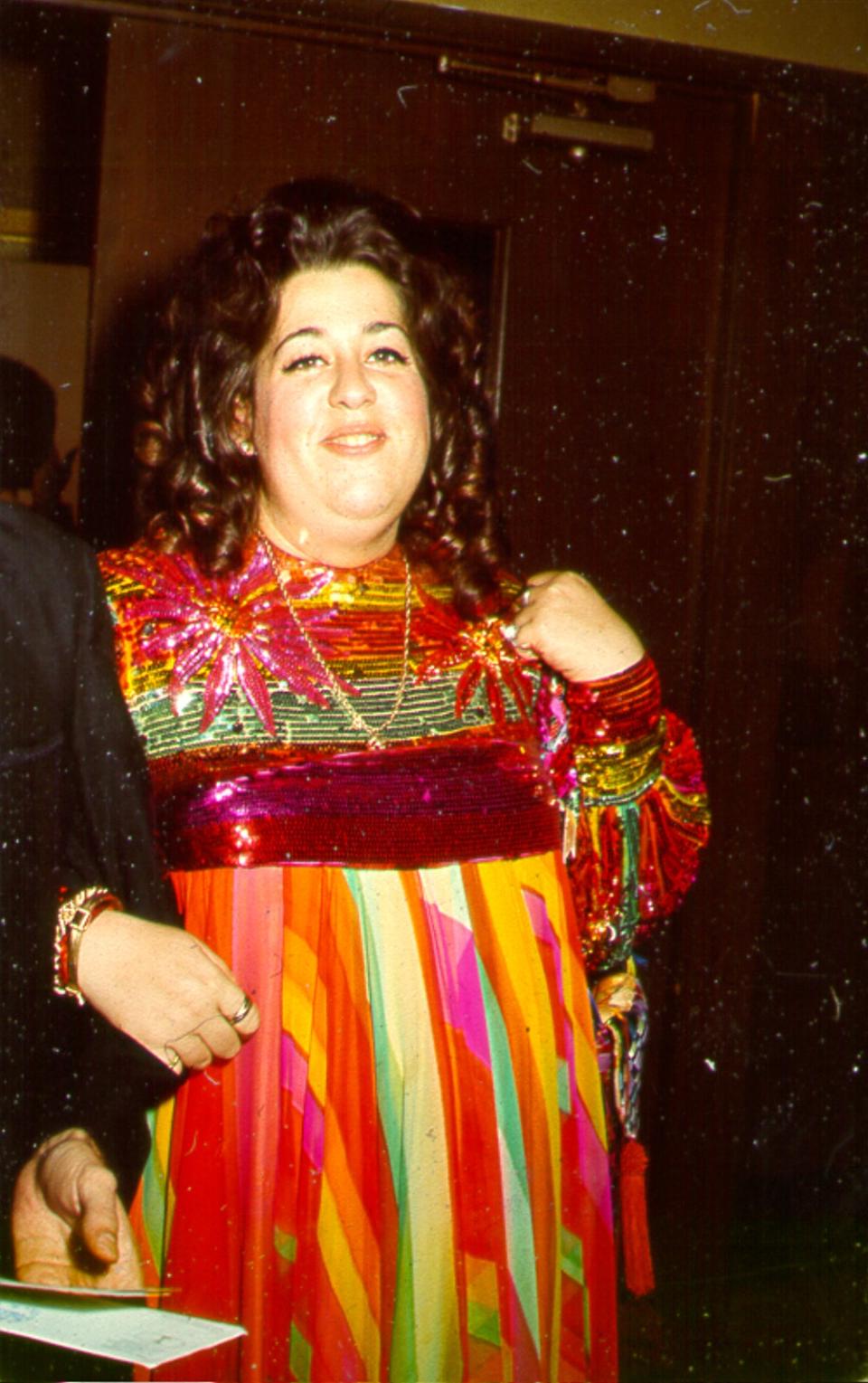 Cass Elliot wearing a colorful dress