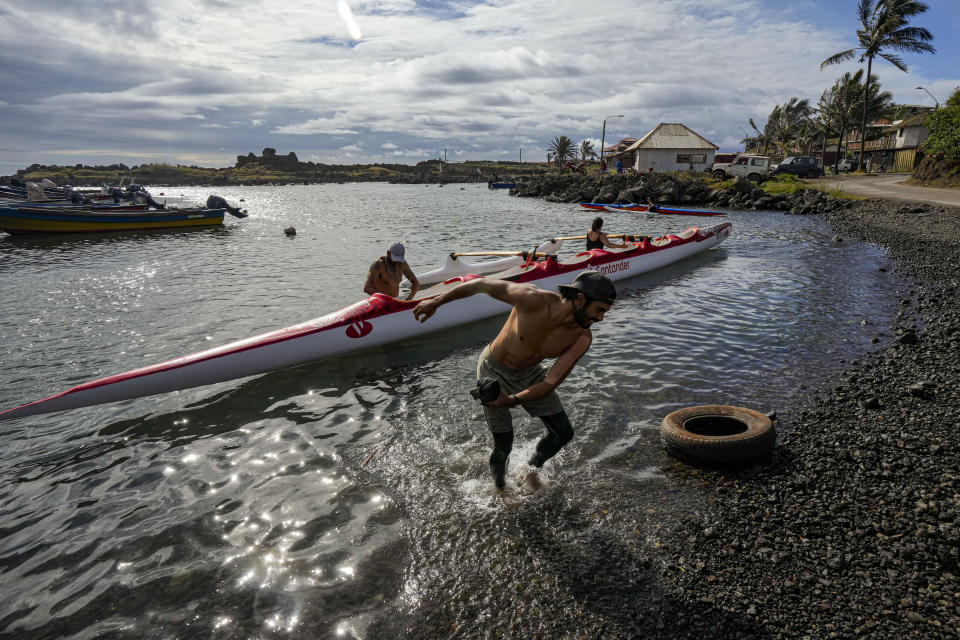 Crew members prepare for a training session for the Hoki Mai challenge, a canoe voyage — covering almost 500 kilometers, or about 300 miles across a stretch of the Pacific Ocean, in Rapa Nui, a territory that is part of Chile and is better known as Easter Island, Thursday, Nov. 24, 2022. Hoki Mai pursues three goals. The first is to honor canoeing in Polynesia, which has been practiced for centuries. The second is related to the environment. The third purpose relates to gender equality. (AP Photo/Esteban Felix)