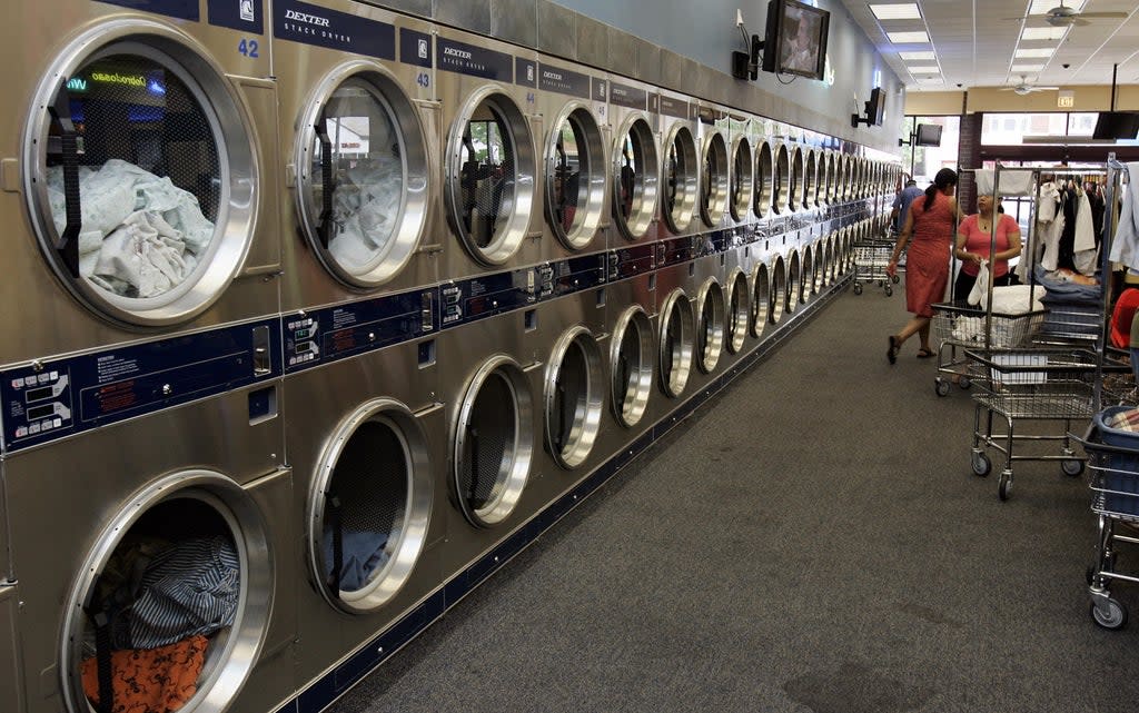 The average UK adults will do around  13,000 loads of laundry in their lifetime  (AFP via Getty Images)