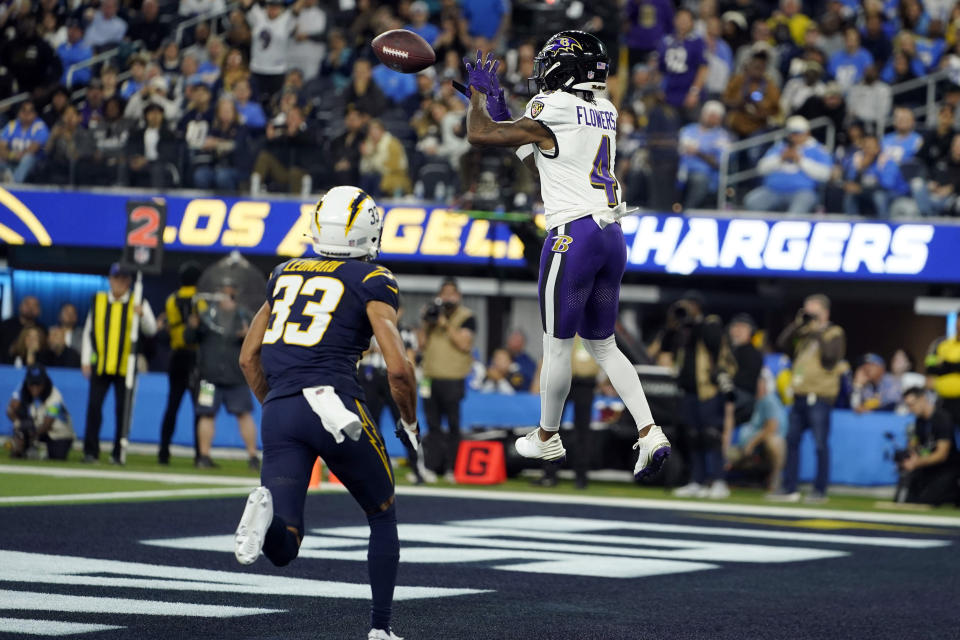 Baltimore Ravens wide receiver Zay Flowers (4) catches a touchdown over Los Angeles Chargers cornerback Deane Leonard (33) during the first half of an NFL football game Sunday, Nov. 26, 2023, in Inglewood, Calif. (AP Photo/Ryan Sun)