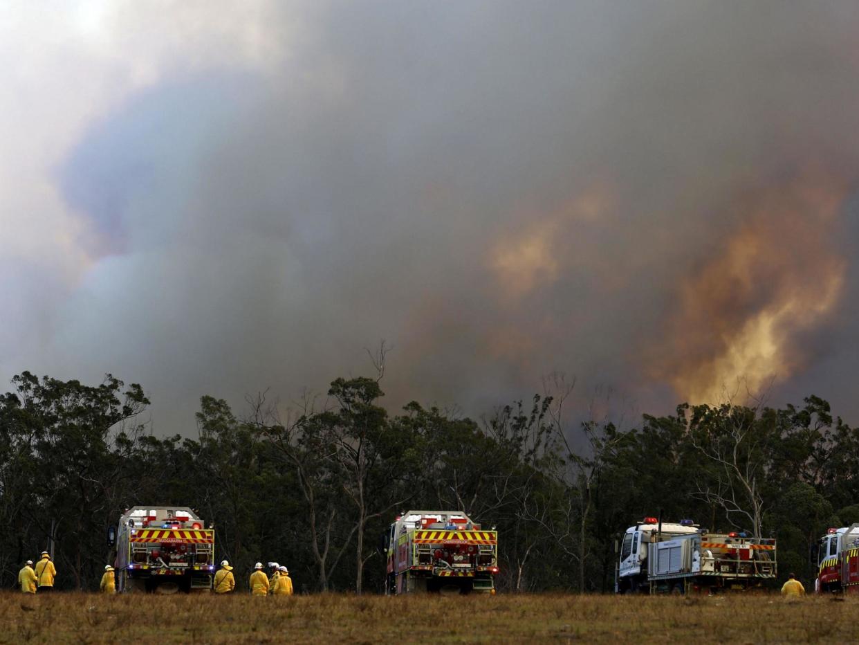 Firefighters prepare for a bushfire approaching in Old Bar, some 350km from central Sydney: EPA