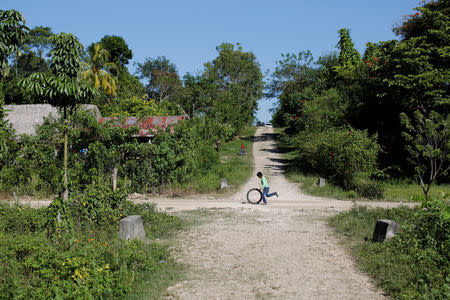 FILE PHOTO: A child plays with a tire in the village where Jakelin, a 7-year-old girl who died in U.S. custody, used to live in San Antonio Secortez, municipality of Raxruha, Guatemala December 19, 2018. REUTERS/Luis Echeverria/File Photo