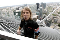 French climber Alain Robert, also known as "Spiderman", scales the 231 metre First Tower at the La Defense business district outside Paris May 10, 2012. REUTERS/Benoit Tessier