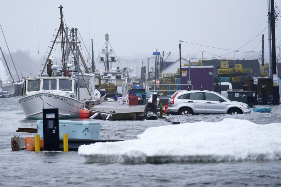 FILE - A car sits in a flooded parking lot at Widgery Wharf in this Jan. 10, 2024, in Portland, Maine. A series of recent storms have drenched the Northeast and slammed it with fierce winds, knocking out power to hundreds of thousands and destroying waterfront property. (AP Photo/Robert F. Bukaty)
