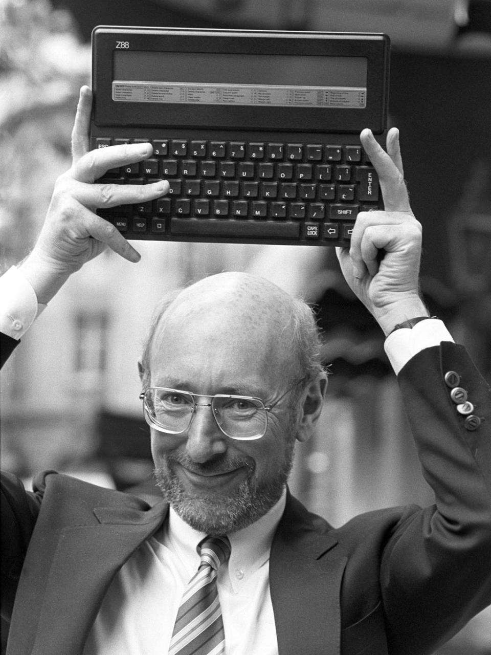Sir Clive holds up the Z88 in September 1987 (PA)