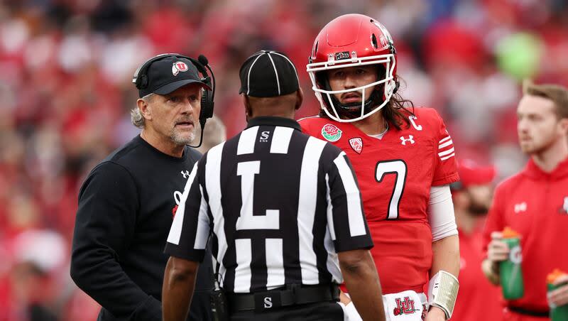 Utah Utes head coach Kyle Whittingham and Utah Utes QB Cameron Rising (7) listen to a official as Utah and Penn State play in the Rose Bowl in Pasadena, Calif., on Monday, Jan. 2, 2023.