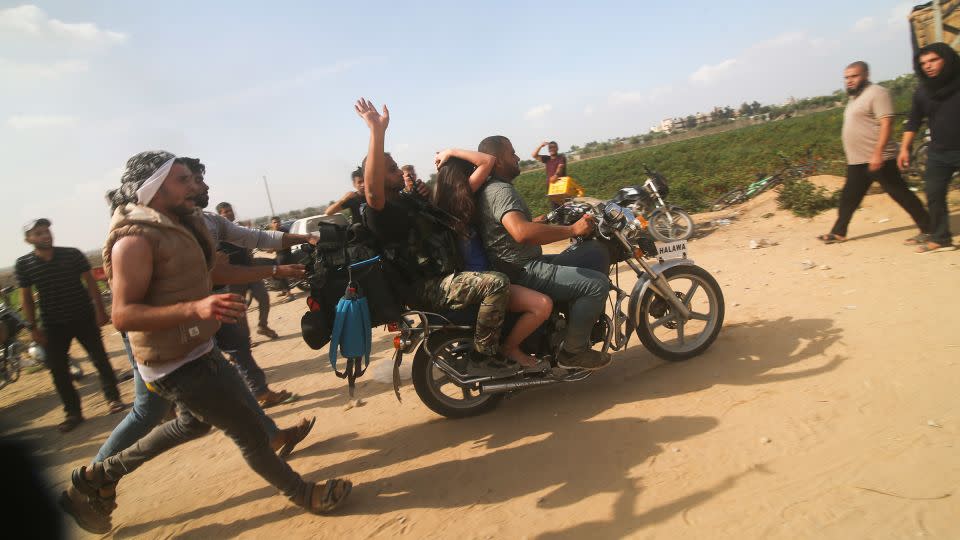 Palestinians transport an Israeli citizen to Gaza after kidnapping her from a kibbutz in Israel near the Gaza border, on Oct. 7, 2023. - Hatem Ali/AP/File