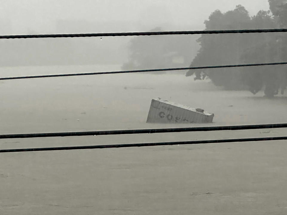 A container floats on swollen Marikina River as monsoon rains worsened by offshore typhoon Gaemi on Wednesday, July 24, 2024, in Manila, Philippines. (AP Photo/Joeal Capulitan)