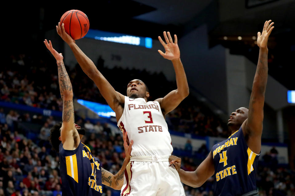 <p>Trent Forrest #3 of the Florida State Seminoles attempts a shot against Tevin Brown #10 and Brion Sanchious #4 of the Murray State Racers in the first half during the second round of the 2019 NCAA Men’s Basketball Tournament at XL Center on March 23, 2019 in Hartford, Connecticut. (Photo by Maddie Meyer/Getty Images) </p>