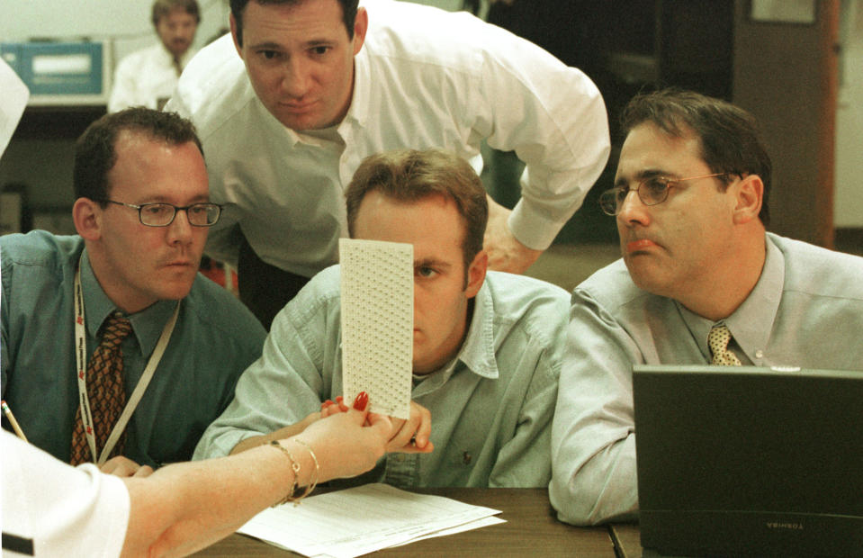 Election employees, reporters and Judicial Watch members look at undervotes at the Broward County Elections warehouse in Fort Lauderdale, Fla., in 2000. (Photo: Robert King/Newsmakers/Getty images)