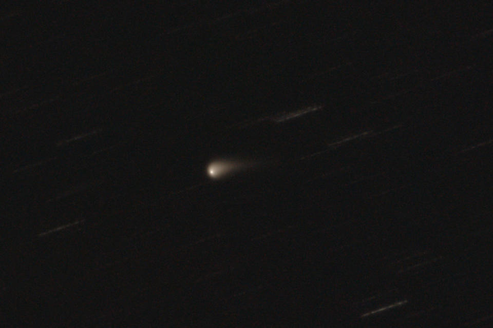 a faint bright sphere can be seen in the night sky