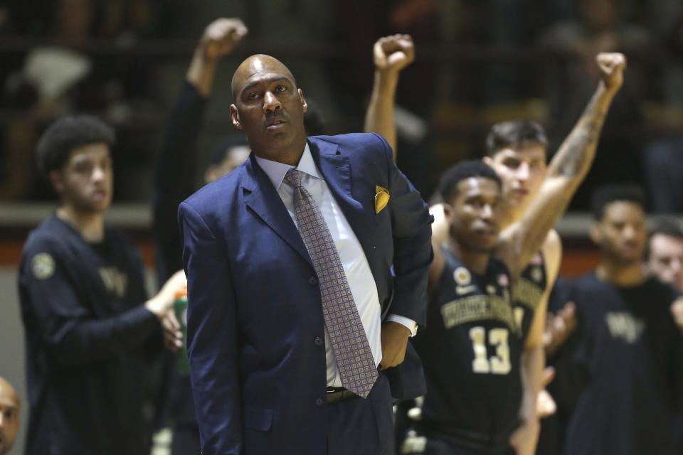 FILE - In this Saturday, March 4, 2017, file photo, Wake Forest head coach Danny Manning watches from the bench during the first half of an NCAA basketball game against Wake Forest in Blacksburg, Va. Whenever John Collins mentions that he plays for Wake Forest, he usually gets a question about his famous coach. Everybody wants to know about Danny and The Miracles. Manning led Kansas to the 1988 national title, knocking off Kansas State along the way. He’s got Wake Forest (19-13) back in the NCAA Tournament for the first time in seven years, facing K-State again. (Matt Gentry/The Roanoke Times via AP, File)