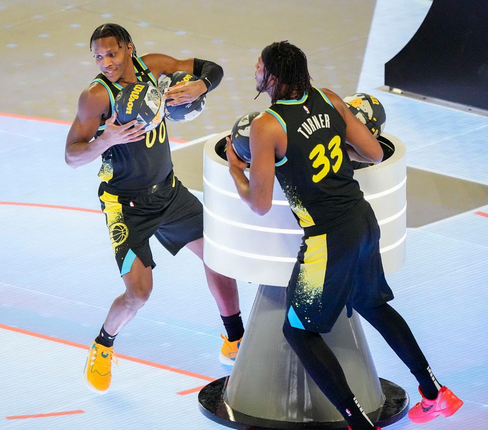 Indiana Pacers guard Bennedict Mathurin (00) and Indiana Pacers center Myles Turner (33) compete in the skills challenge Saturday, Feb. 17, 2024, during NBA All-Star Saturday Night at Lucas Oil Stadium in downtown Indianapolis.
