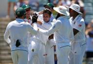Cricket - Australia v South Africa - First Test cricket match - WACA Ground, Perth, Australia - 4/11/16 South Africa's Keshav Maharaj celebrates with team mates after dismissing Australia's captain Steve Smith LBW at the WACA Ground in Perth. REUTERS/David Gray