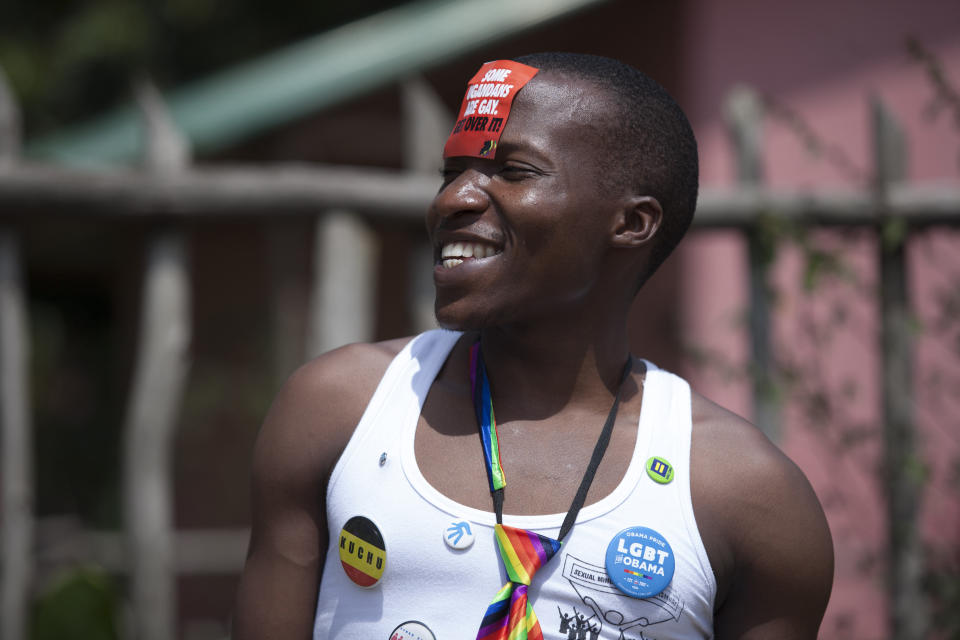 A Ugandan laughs during the 3rd Annual Lesbian, Gay, Bisexual and Transgender (LGBT) Pride celebrations in Entebbe, Uganda, Saturday, Aug. 9, 2014.  Scores of Ugandan homosexuals and their supporters are holding a gay pride parade on a beach in the lakeside town of Entebbe. The parade is their first public event since a Ugandan court invalidated an anti-gay law that was widely condemned by some Western governments and rights watchdogs.(AP Photo/Rebecca Vassie)