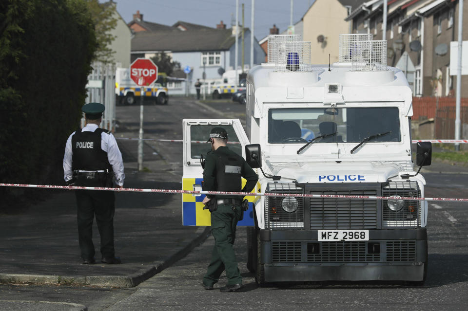 Police at the scene in Londonderry, Northern Ireland, Friday April 19, 2019, following the death of 29-year-old journalist Lyra McKee who was shot and killed during overnight rioting. Police in Northern Ireland said Friday the dissident republican group the New IRA was probably responsible for the fatal shooting of a journalist during overnight rioting in the city of Londonderry. (Brian Lawless/PA via AP)