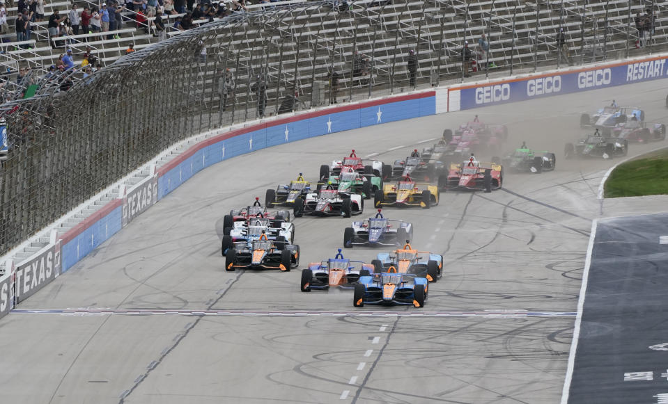 Felix Rosenqvist (6), center, of Sweden, leads at the start of an IndyCar auto race at Texas Motor Speedway in Fort Worth, Texas, Sunday, April 2, 2023.(AP Photo/Larry Papke)