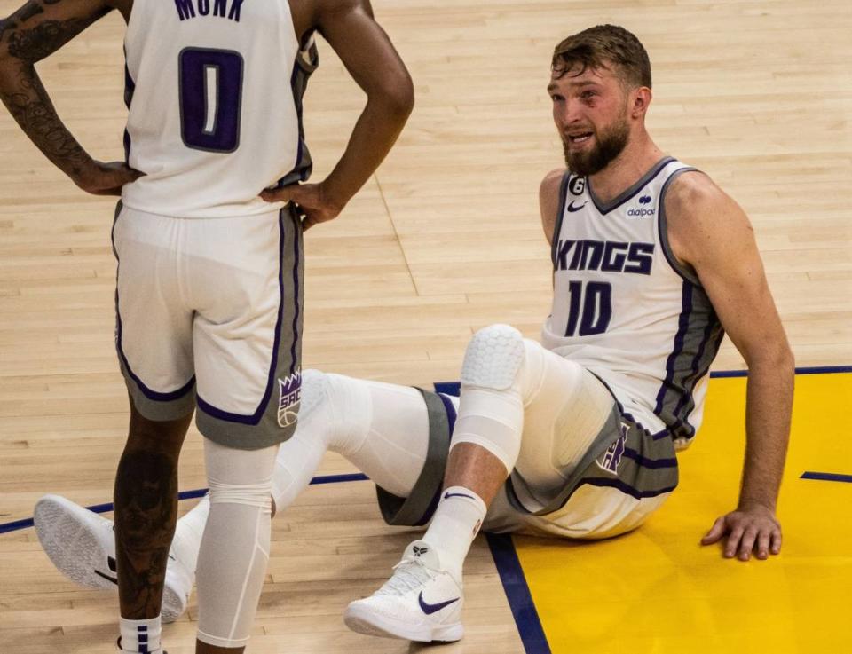 Sacramento Kings center Domantas Sabonis (10) looks at guard Malik Monk (0) after he was elbowed in the face by Golden State’s Kevon Looney during a jump ball during Game 6 of the first-round NBA playoff series at Chase Center on Friday, April 28, 2023.