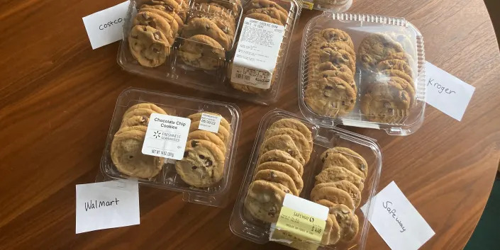 groups of cookies in plastic containers with notes on table