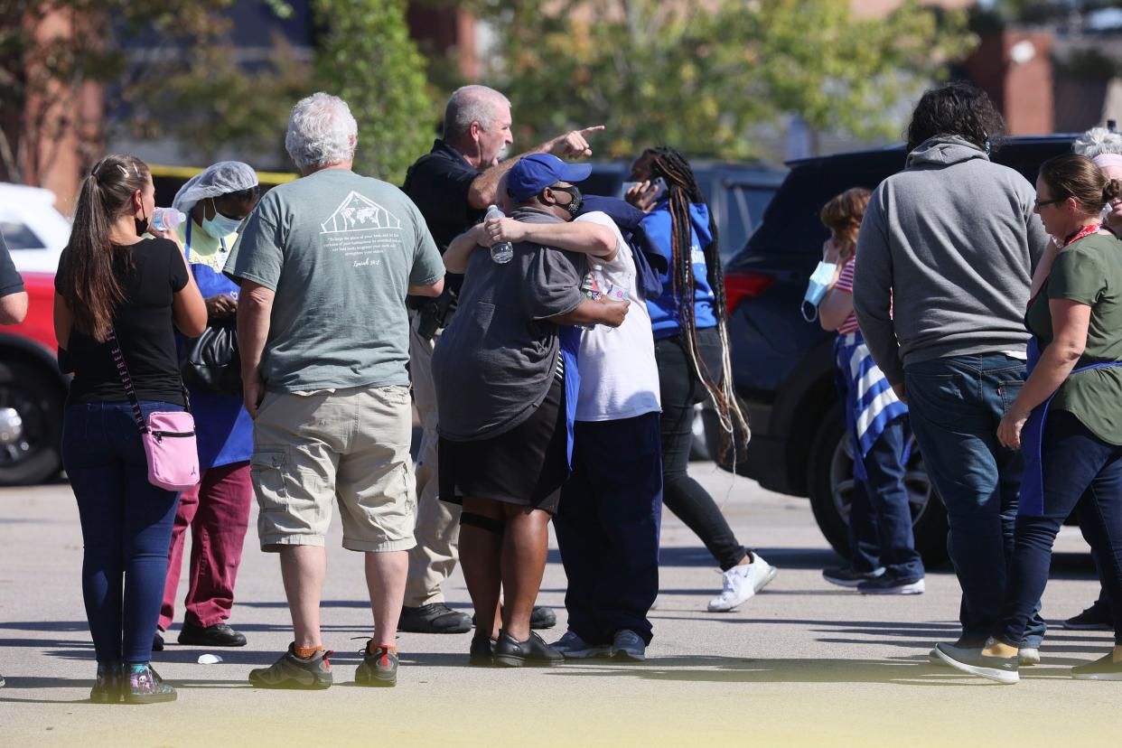 People embrace as police respond to the scene of a shooting at a Kroger’s grocery store in Collierville, Tennessee (AP)