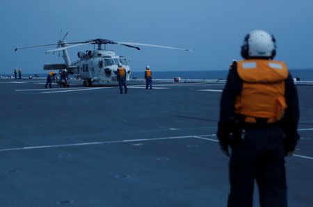 Japan Maritime Self-Defense Force (JMSDF) SH-60 Seahawk helicopter is seen on the flight deck of JMSDF's helicopter carrier Izumo during a military exercise in South China Sea, near Singapore, June 20, 2017. Picture taken June 20, 2017. REUTERS/Nobuhiro Kubo