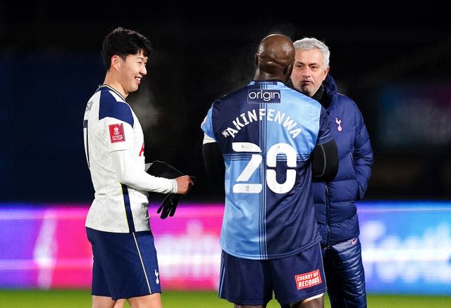 Jose Mourinho, right, talks to Wycombe's Adebayo Akinfenwa