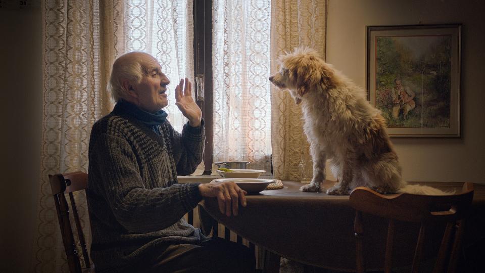 This image released by Sony Pictures Classics shows Aurelio Conterno and his dog Birba in a scene from "The Truffle Hunters." (Sony Pictures Classics via AP)