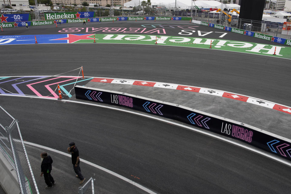 People walk along the exit of the pit during work ahead of the the Formula One Las Vegas Grand Prix auto race, Wednesday, Nov. 15, 2023, in Las Vegas. (AP Photo/John Locher)