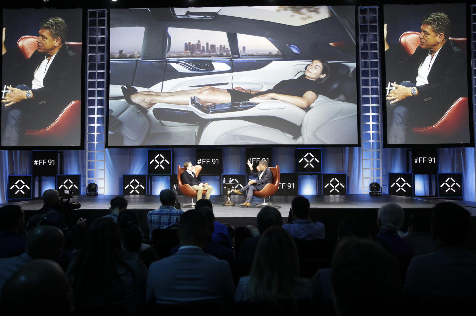 Tim Higgins, of The Wall Street Journal, left, and Dr. Carsten Breitfeld, Global CEO of Faraday Future, participate in the technology panel " Faraday's Future: Transforming the Road of Future mobility," at the AutoMobility LA auto show at the Los Angeles Convention Center in Los Angeles Tuesday, Nov. 19, 2019. (AP Photo/Damian Dovarganes)