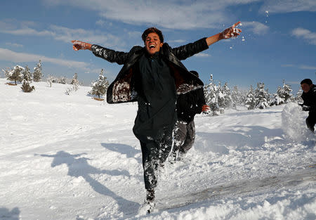 FILE PHOTO: Afghan boys play on the snow covered ground in Kabul, Afghanistan, January 5, 2019. REUTERS/Omar Sobhani