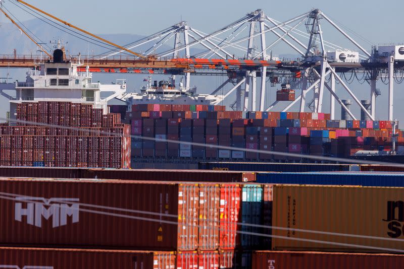 FILE PHOTO: Stacked containers are shown as ships unload their cargo at the Port of Los Angeles