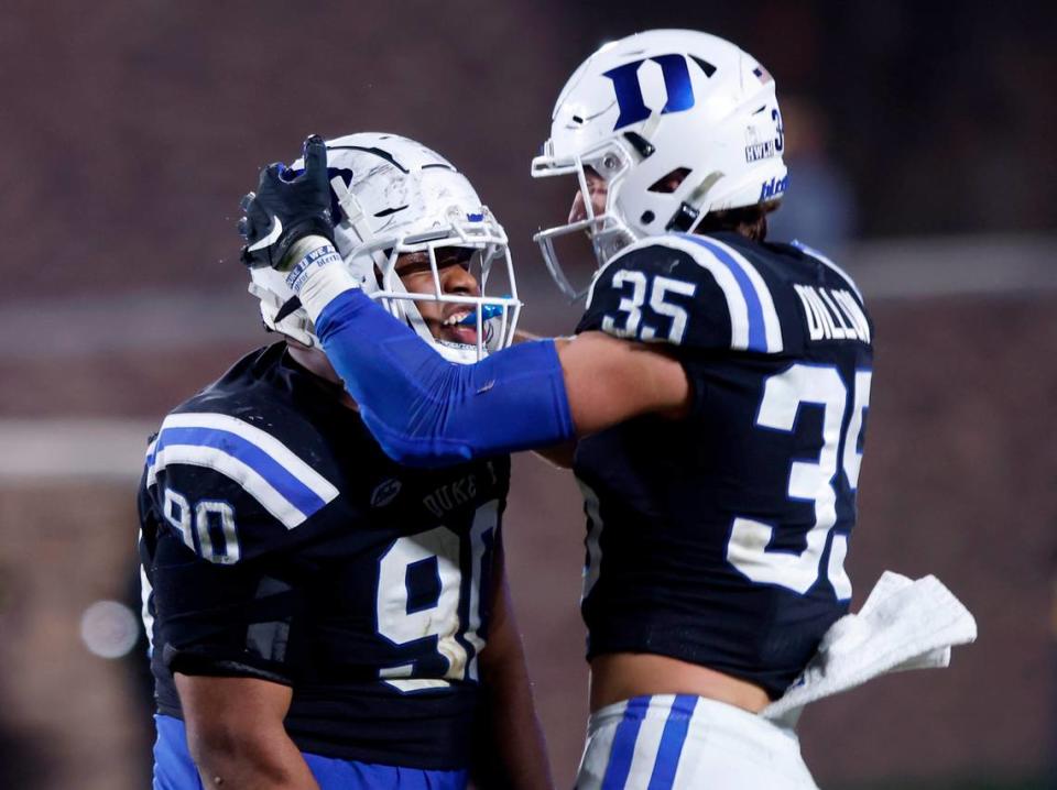 Duke’s DeWayne Carter celebrates with Cam Dillon after sacking Wake Forest quarterback Sam Hartman during the second half of the Blue Devils’ final regular season game at Wallace Wade Stadium on Saturday, Nov. 26, 2022, in Durham, N.C.