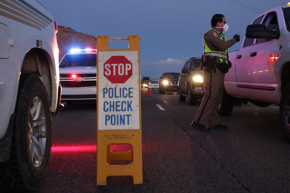 Navajo police officers from the Shiprock District conduct a checkpoint on April 1, 2020 to remind the public about the nightly curfew on the Navajo Nation.
