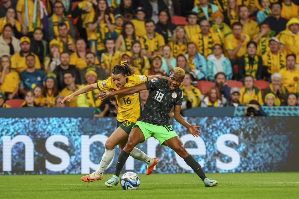 Nigeria's Halimatu Ayinde, right, fights for the ball with Australia's Hayley Raso during the Women's World Cup Group B soccer match between Australia and Nigeria In Brisbane, Australia, Thursday, July 27, 2023. (AP Photo/Tertius Pickard)