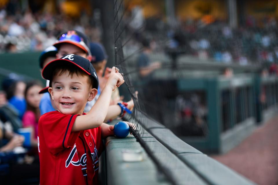 Banks Baldridge, 5, enjoys watching baseball at Fluor Field during the Greenville Drive game on Wednesday, April 12, 2023.